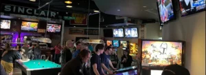 Folks enjoying pool and pinball at Carpool